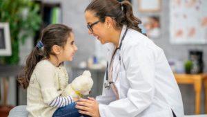 smiling child and doctor together