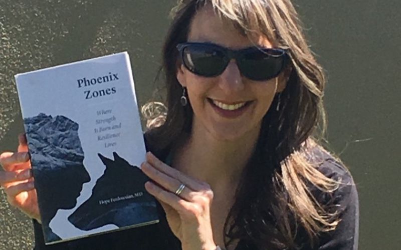 Dr. Hope Ferdowsian is holding her first book, Phoenix Zones