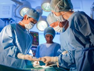 Image of surgical staff engaged in surgery--Xenotransplantation has many ethical problems